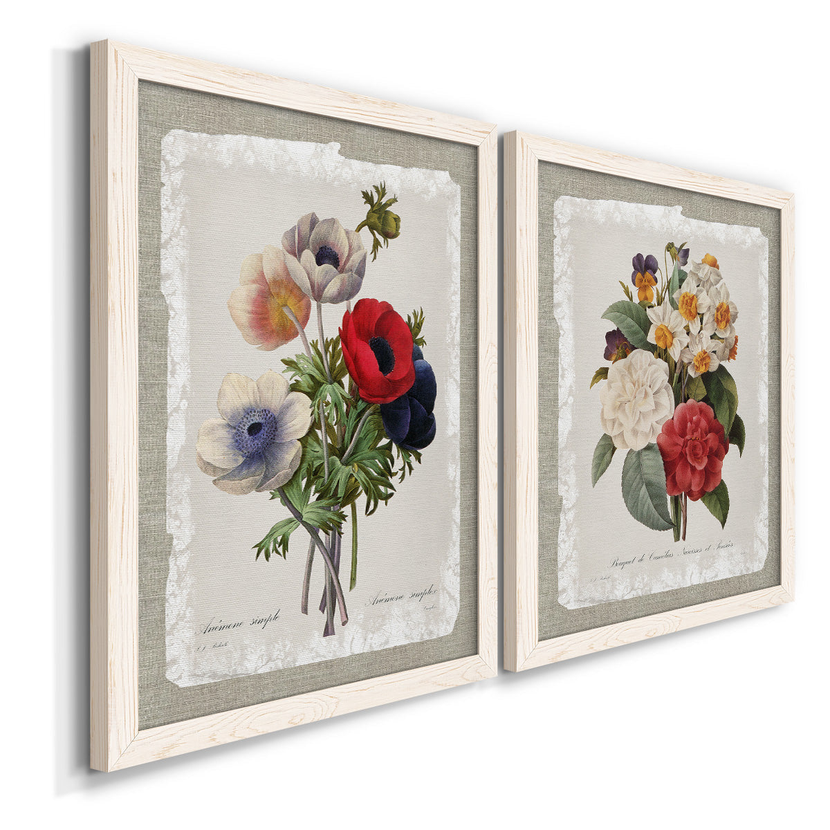 Angled view of a set of two white barnwood framed canvas prints featuring two traditional botanical collage prints featuring vintage mixed-flower bouquets on distressed paper.