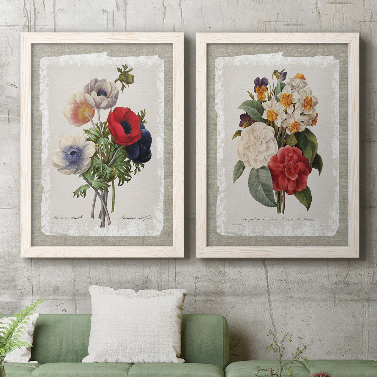 Set of two white barnwood framed canvas prints depicting a coordinated art pair of vintage mixed-flower bouquets on distressed paper rendered as traditional botanical collage prints above a sofa in a modern living room.