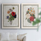 Set of two white barnwood framed canvas prints depicting roses anemones carnations leaves and archival script details arranged across two complementary compositions above a sofa in a bright living space.