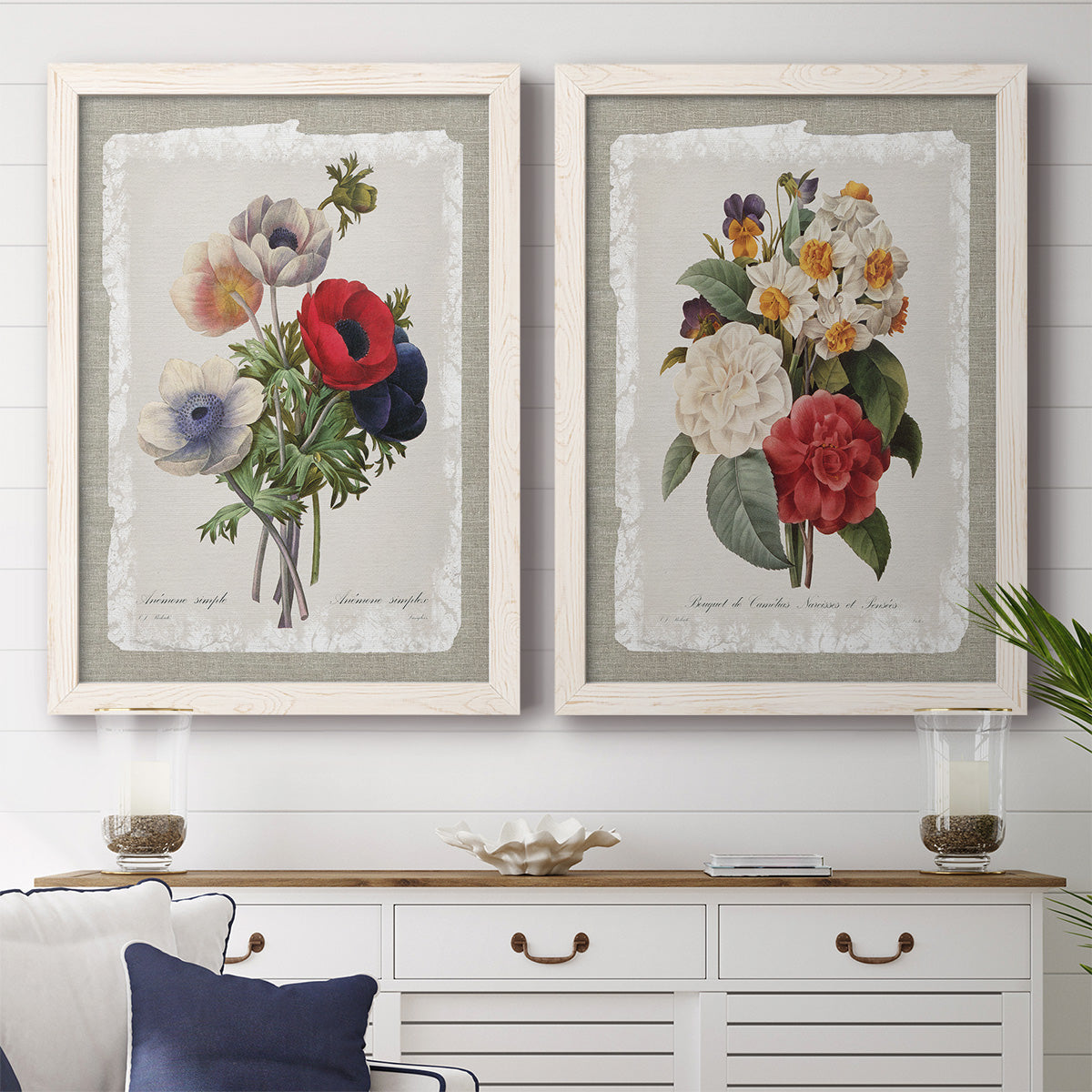 Set of two white barnwood framed canvas prints depicting a coordinated art pair of vintage mixed-flower bouquets on distressed paper rendered as traditional botanical collage prints above a dining room sideboard.