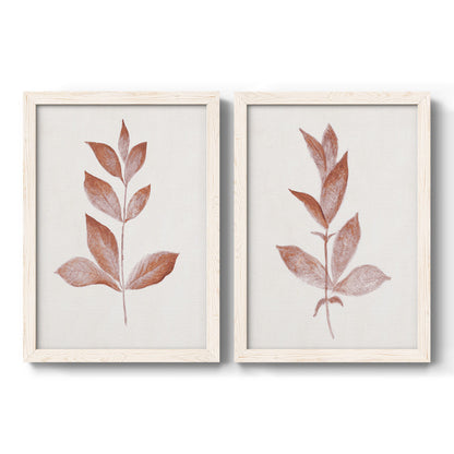 Set of two white barnwood framed canvas prints featuring two minimalist botanical prints featuring single rust-red leafy stems.