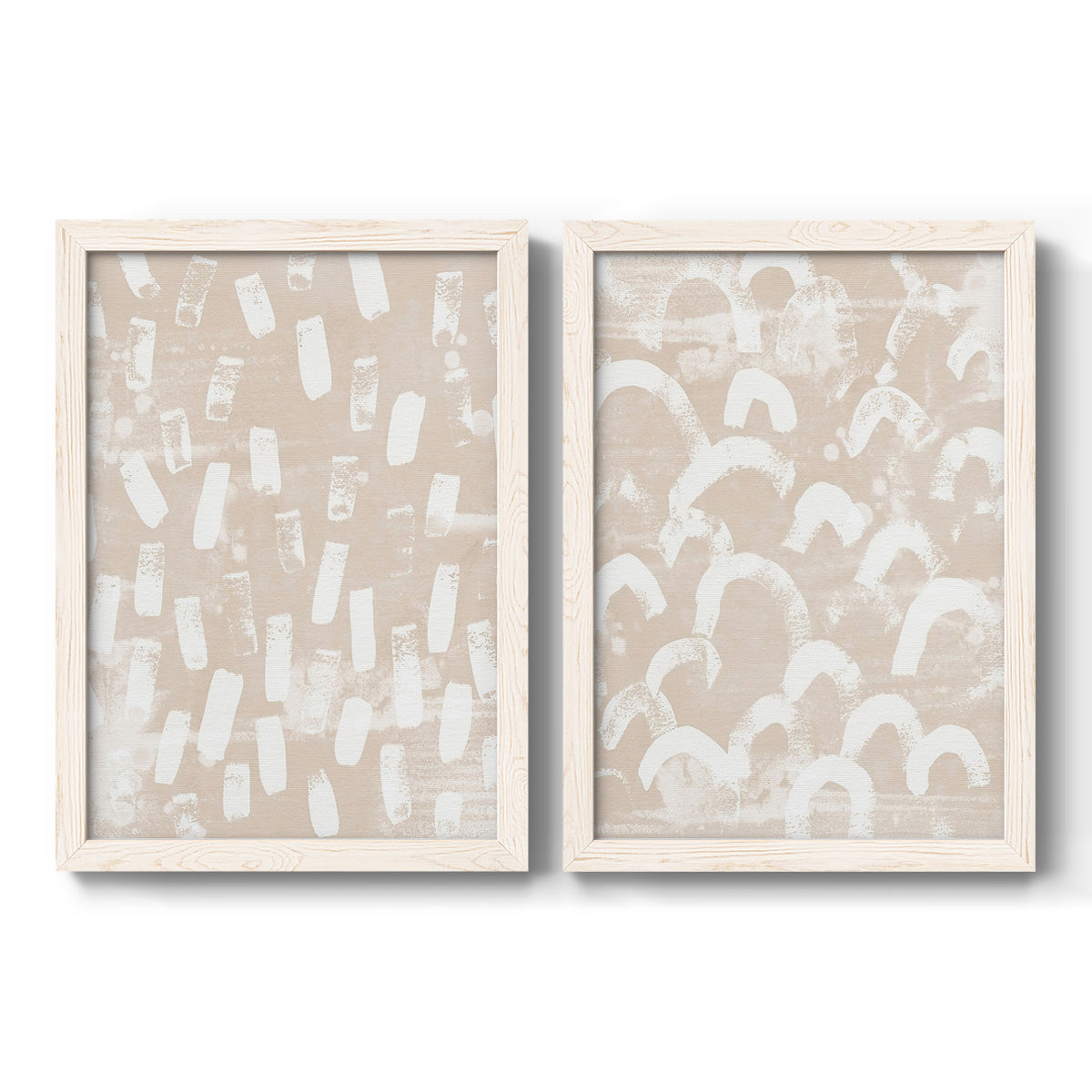 Set of two white barnwood framed canvas prints featuring two tribal-inspired pattern abstracts featuring white hand-painted dashes arcs and chevrons.