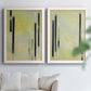 Set of two white barnwood framed canvas prints depicting slender rectangular elements, pale yellow fields, and subtle layered texture arranged across two complementary compositions above a sofa in a bright living space.
