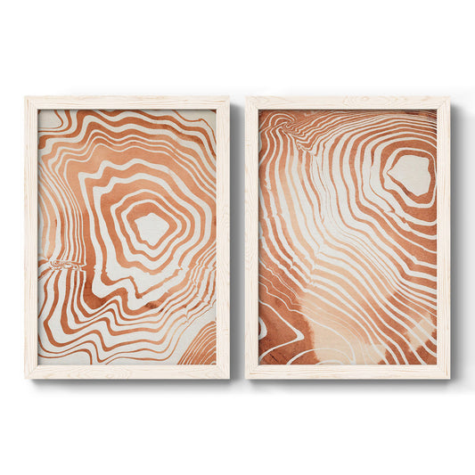 Set of two white barnwood framed canvas prints featuring two minimalist marbled pattern abstracts featuring concentric wood-grain rings and rippling contour lines.