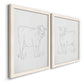 Angled view of a set of two white barnwood framed canvas prints featuring two minimalist livestock sketches featuring simple contour drawings of standing cows.