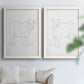 Set of two white barnwood framed canvas prints depicting fine gray lines, white backgrounds, and quiet farm-animal profiles arranged across two complementary compositions above a sofa in a bright living space.