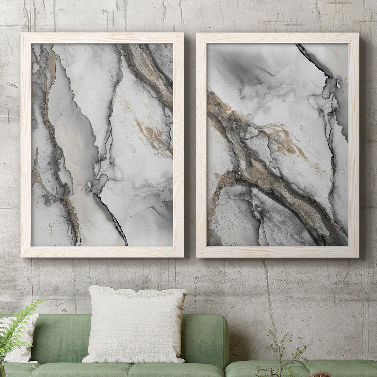 Set of two white barnwood framed canvas prints depicting a monochrome abstract pair of smoky ink washes fractured lines and warm gold accents above a sofa in a modern living room.