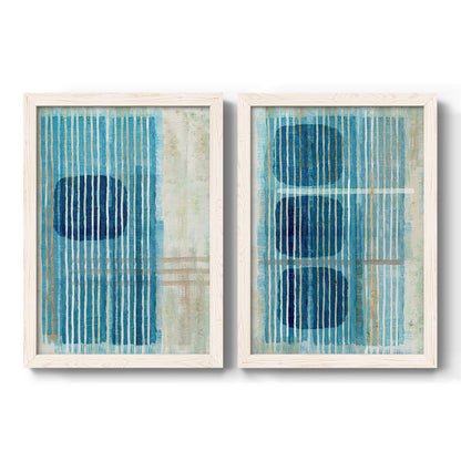 Set of two white barnwood framed canvas prints featuring two graphic geometric abstracts featuring stacked blue ovals behind fine vertical stripes.