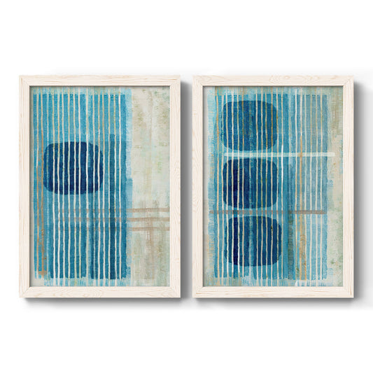 Set of two white barnwood framed canvas prints featuring two graphic geometric abstracts featuring stacked blue ovals behind fine vertical stripes.