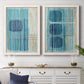 Set of two white barnwood framed canvas prints depicting a coordinated art pair of stacked blue ovals behind fine vertical stripes rendered as graphic geometric abstracts above a dining room sideboard.