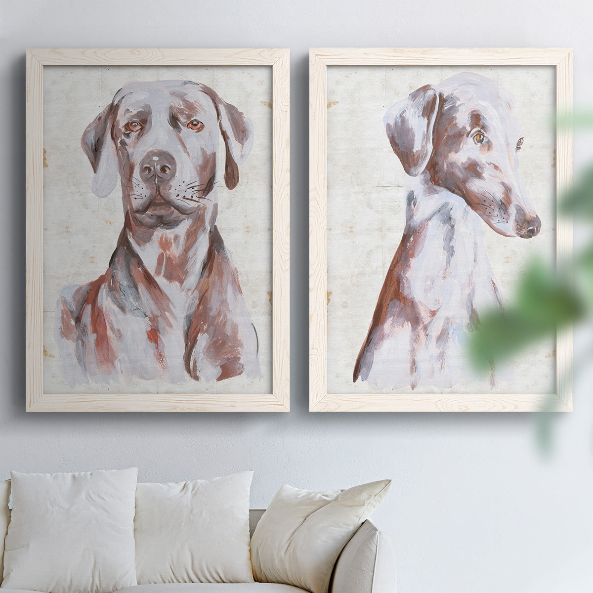 Set of two white barnwood framed canvas prints depicting soft brown and gray fur, expressive faces, and lightly distressed cream grounds arranged across two complementary compositions above a sofa in a bright living space.