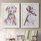 Set of two white barnwood framed canvas prints depicting two traditional watercolor pet paintings featuring gentle seated dog portraits above a sideboard in a cozy sitting room.