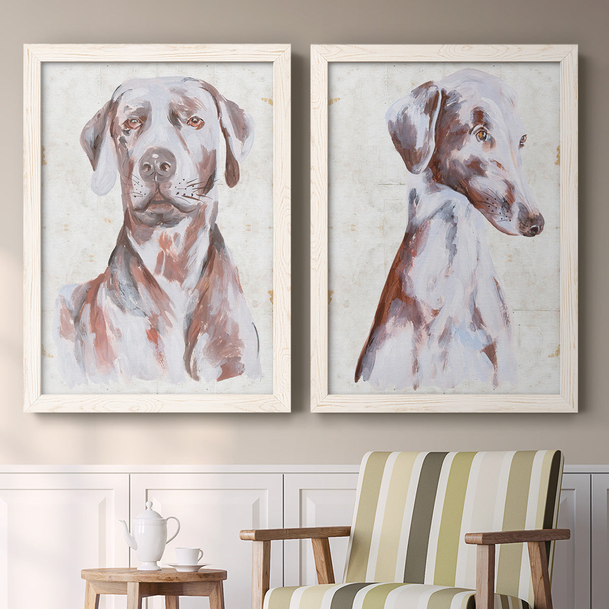 Set of two white barnwood framed canvas prints depicting two traditional watercolor pet paintings featuring gentle seated dog portraits above a sideboard in a cozy sitting room.