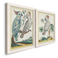 Angled view of a set of two white barnwood framed canvas prints featuring two atmospheric abstract paintings featuring misty blue gray and violet marks hovering across pale grounds.