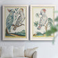 Set of two white barnwood framed canvas prints depicting soft clustered strokes, hazy edges, and spacious white fields arranged across two complementary compositions above a sofa in a bright living space.