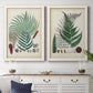 Set of two white barnwood framed canvas prints depicting a coordinated art pair of vintage fern specimens with botanical details rendered as natural-history fern plates above a dining room sideboard.