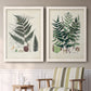 Set of two white barnwood framed canvas prints depicting two natural-history fern plates featuring vintage fern specimens with botanical details above a sideboard in a cozy sitting room.