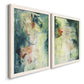 Angled view of a set of two white barnwood framed canvas prints featuring two nature-inspired mixed-media abstracts featuring layered blue green cream and charcoal textures.