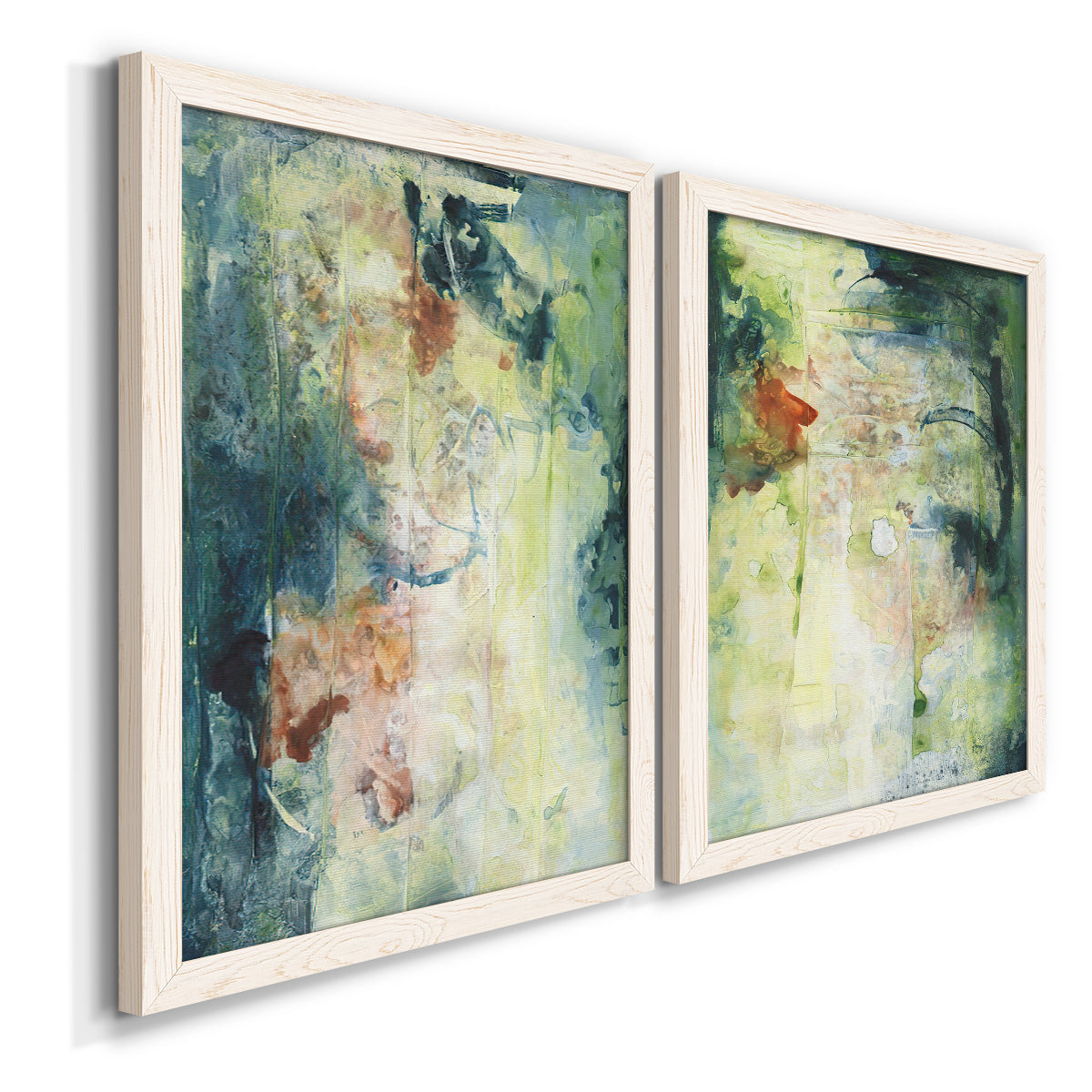 Angled view of a set of two white barnwood framed canvas prints featuring two nature-inspired mixed-media abstracts featuring layered blue green cream and charcoal textures.