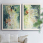 Set of two white barnwood framed canvas prints depicting vertical organic marks, pale light passages, and weathered surfaces arranged across two complementary compositions above a sofa in a bright living space.