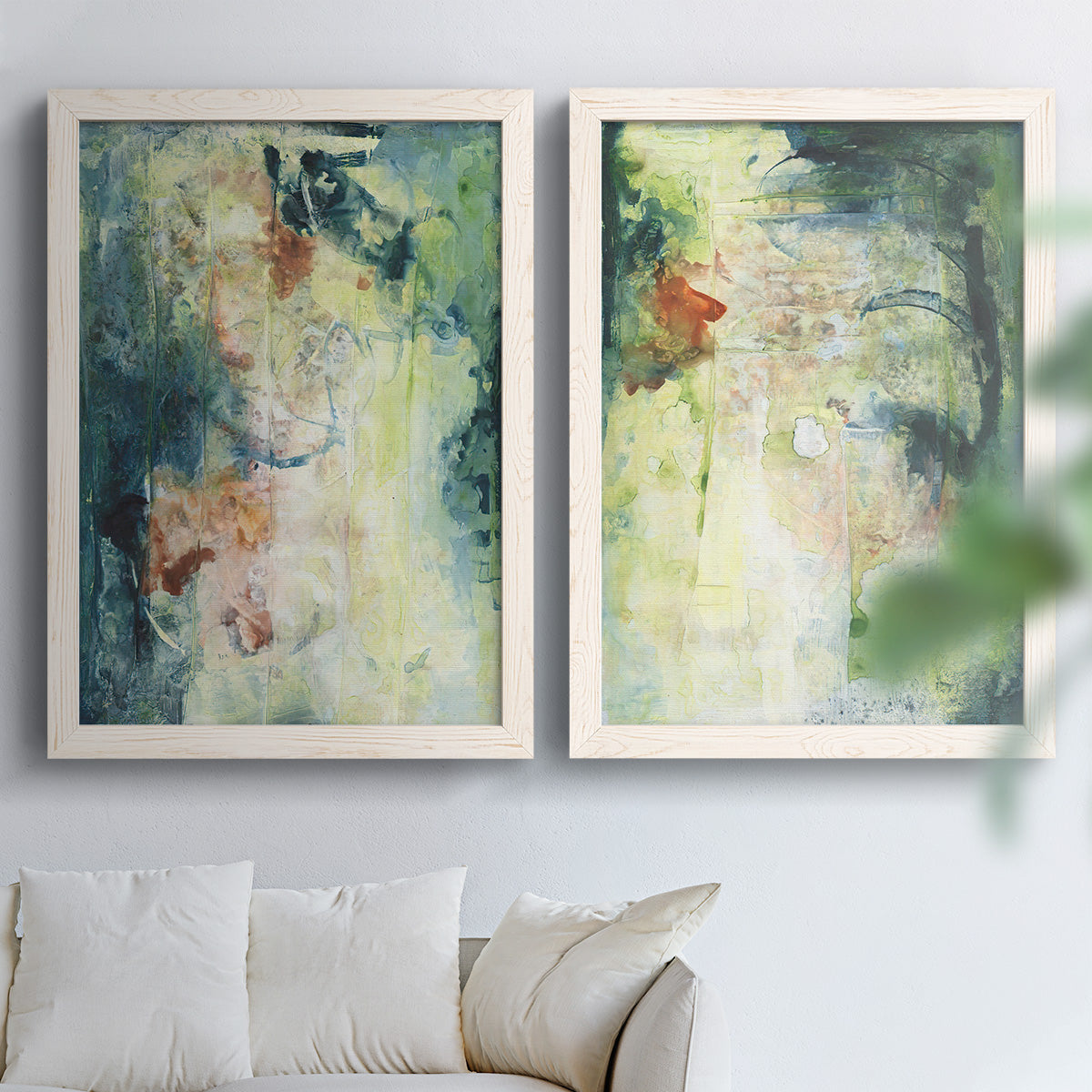 Set of two white barnwood framed canvas prints depicting vertical organic marks, pale light passages, and weathered surfaces arranged across two complementary compositions above a sofa in a bright living space.