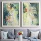 Set of two white barnwood framed canvas prints depicting paired nature-inspired mixed-media abstracts with vertical organic marks, pale light passages, and weathered surfaces above a sofa in a contemporary living room.