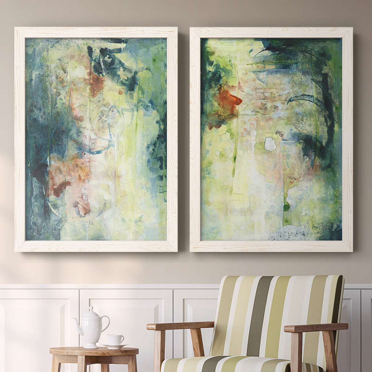 Set of two white barnwood framed canvas prints depicting two nature-inspired mixed-media abstracts featuring layered blue green cream and charcoal textures above a sideboard in a cozy sitting room.