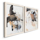 Angled view of a set of two white barnwood framed canvas prints featuring two bold mixed-media abstracts featuring energetic black white tan and gray painted gestures.