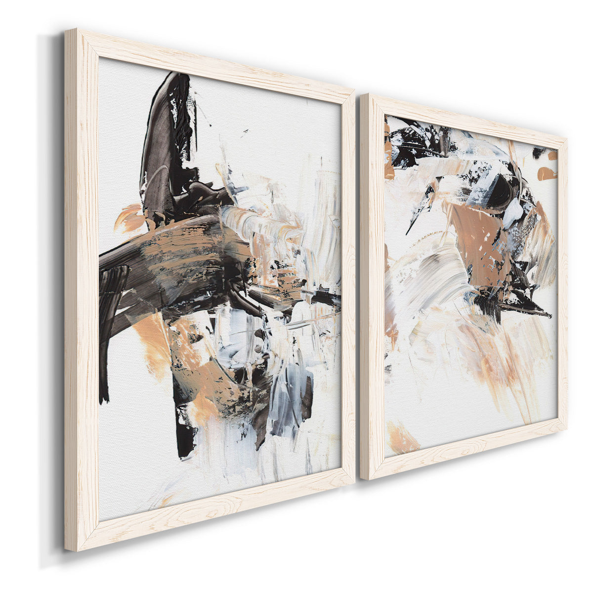 Angled view of a set of two white barnwood framed canvas prints featuring two bold mixed-media abstracts featuring energetic black white tan and gray painted gestures.