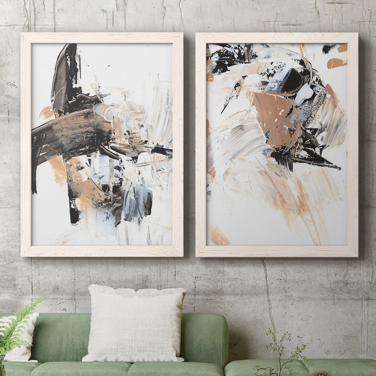 Set of two white barnwood framed canvas prints depicting a coordinated art pair of energetic black white tan and gray painted gestures rendered as bold mixed-media abstracts above a sofa in a modern living room.