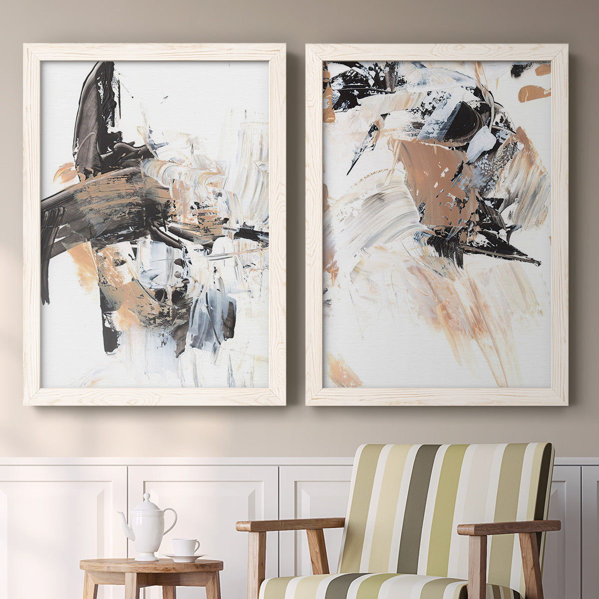 Set of two white barnwood framed canvas prints depicting two bold mixed-media abstracts featuring energetic black white tan and gray painted gestures above a sideboard in a cozy sitting room.