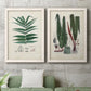 Set of two white barnwood framed canvas prints depicting a coordinated art pair of vintage fern specimens with botanical details rendered as natural-history fern plates above a sofa in a modern living room.