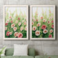 Set of two white barnwood framed canvas prints depicting a coordinated art pair of a field of pink coral and white flowers rendered as luminous impressionistic floral paintings above a sofa in a modern living room.