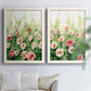 Set of two white barnwood framed canvas prints depicting loose blossoms, green stems, and sunlit watercolor texture arranged across two complementary compositions above a sofa in a bright living space.