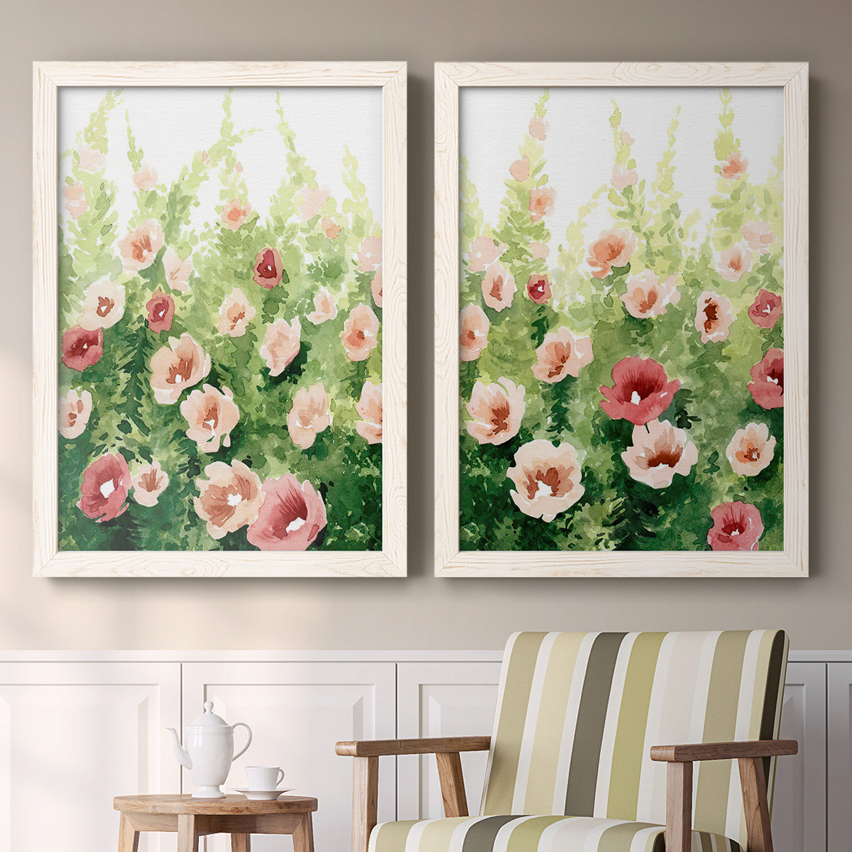 Set of two white barnwood framed canvas prints depicting two luminous impressionistic floral paintings featuring a field of pink coral and white flowers above a sideboard in a cozy sitting room.
