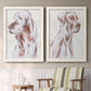 Set of two white barnwood framed canvas prints depicting two traditional watercolor pet paintings featuring gentle seated dog portraits above a sideboard in a cozy sitting room.