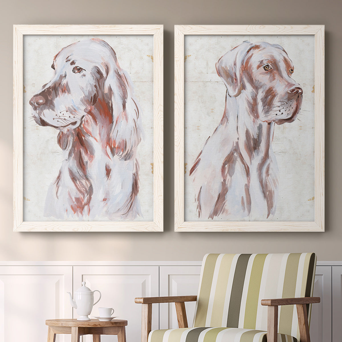 Set of two white barnwood framed canvas prints depicting two traditional watercolor pet paintings featuring gentle seated dog portraits above a sideboard in a cozy sitting room.