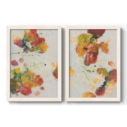Set of two white barnwood framed canvas prints featuring two playful watercolor abstracts featuring scattered coral yellow green and blue paint clusters.