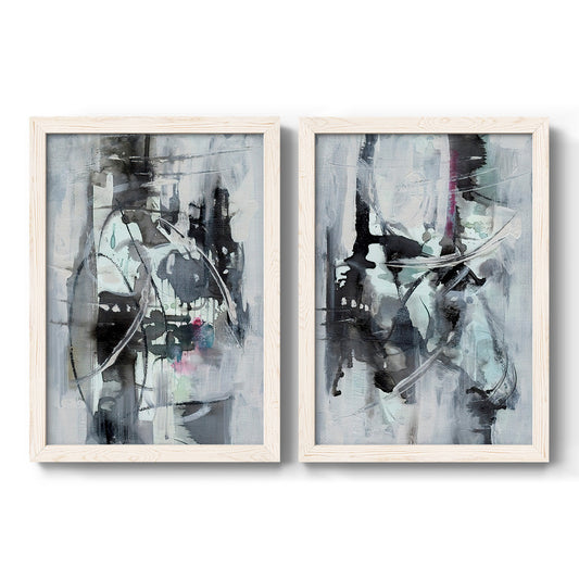 Set of two white barnwood framed canvas prints featuring two high-contrast mixed-media abstracts featuring black gray and pale blue gestural marks.