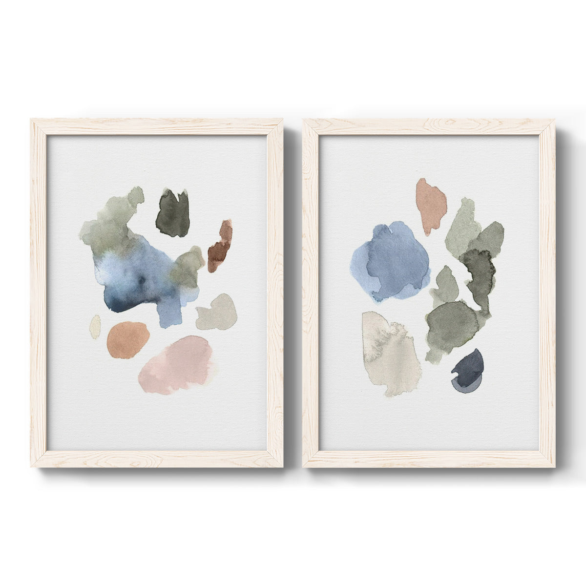 Set of two white barnwood framed canvas prints featuring two airy minimalist abstracts featuring scattered translucent watercolor shapes.