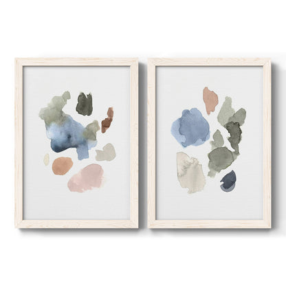 Set of two white barnwood framed canvas prints featuring two airy minimalist abstracts featuring scattered translucent watercolor shapes.