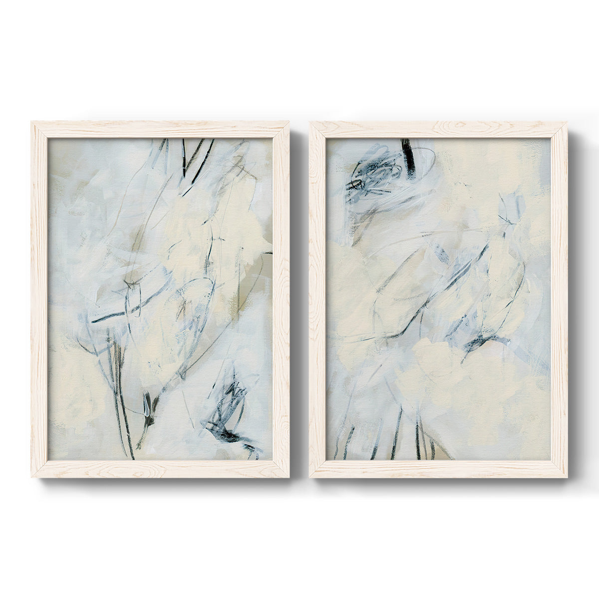 Set of two white barnwood framed canvas prints featuring two airy gestural abstracts featuring pale blue cream and charcoal marks drifting across white.