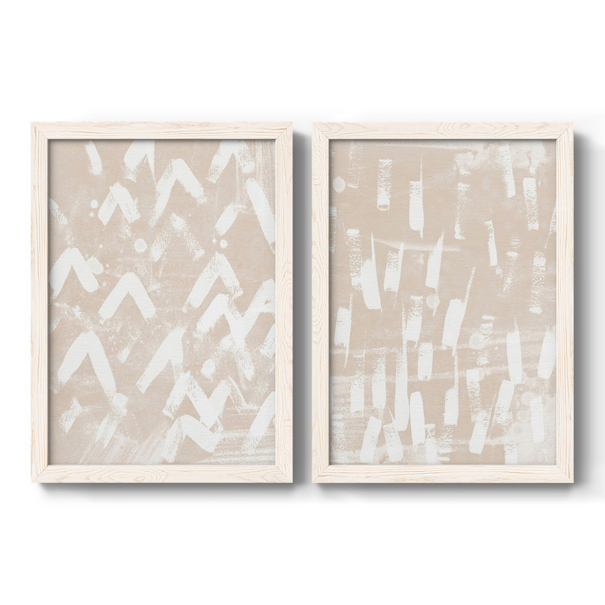 Set of two white barnwood framed canvas prints featuring two tribal-inspired pattern abstracts featuring white hand-painted dashes arcs and chevrons.