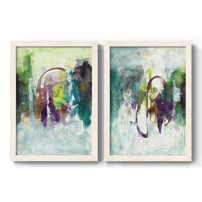 Set of two white barnwood framed canvas prints featuring two expressive contemporary abstracts featuring layered green purple and gray painterly forms.