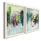 Angled view of a set of two white barnwood framed canvas prints featuring two expressive contemporary abstracts featuring layered green purple and gray painterly forms.