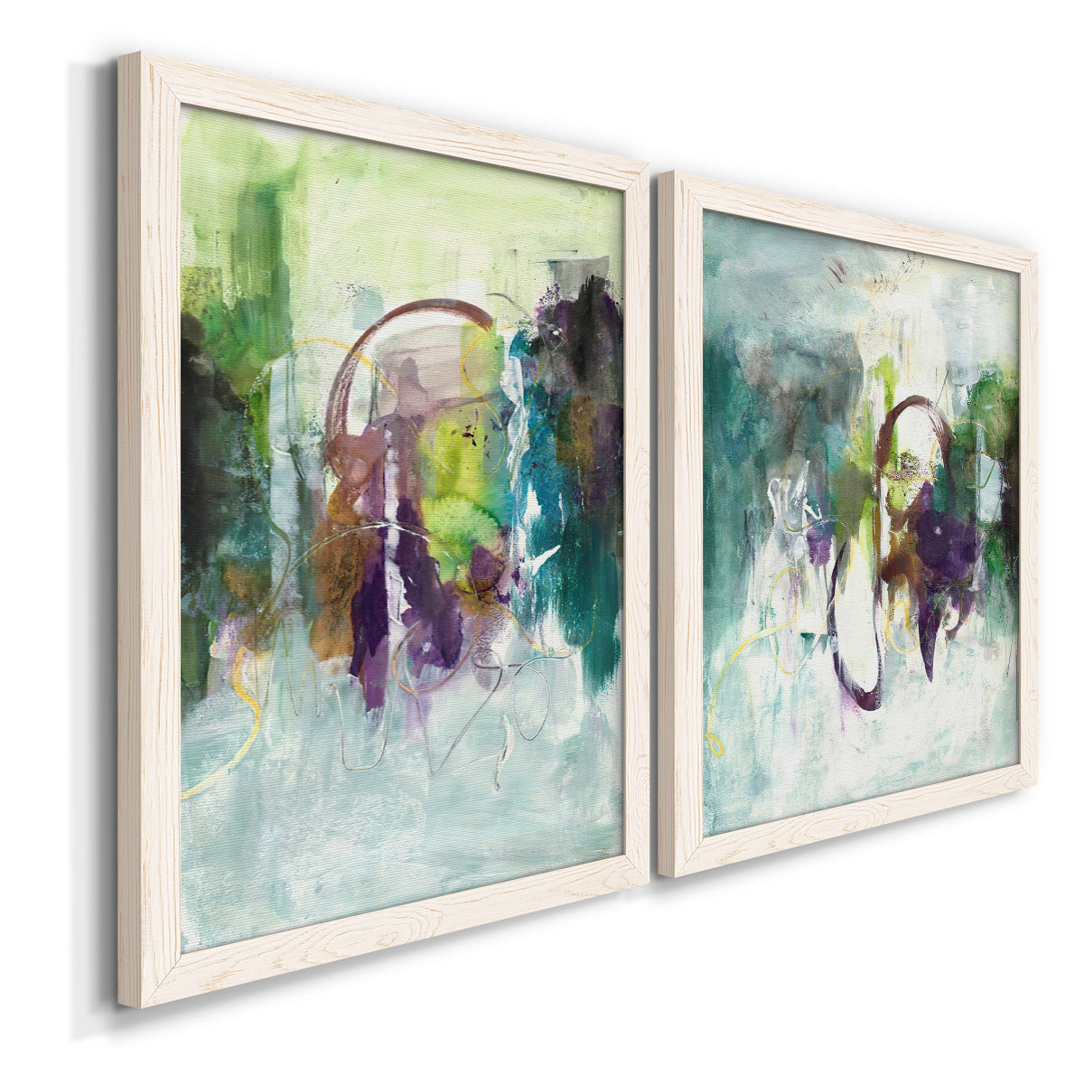 Angled view of a set of two white barnwood framed canvas prints featuring two expressive contemporary abstracts featuring layered green purple and gray painterly forms.