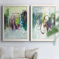 Set of two white barnwood framed canvas prints depicting soft-edged color masses, looping lines, and pale blue grounds arranged across two complementary compositions above a sofa in a bright living space.