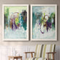 Set of two white barnwood framed canvas prints depicting two expressive contemporary abstracts featuring layered green purple and gray painterly forms above a sideboard in a cozy sitting room.