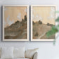 Set of two white barnwood framed canvas prints depicting layered ridges, soft earth tones, and hazy cream skies arranged across two complementary compositions above a sofa in a bright living space.