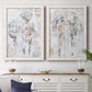 Set of two white barnwood framed canvas prints depicting a coordinated art pair of loosely suggested flowers and stems in pale gray and peach rendered as expressive floral abstracts above a dining room sideboard.